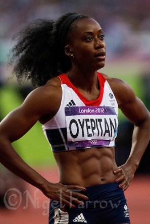 04 AUG 2012 - LONDON, GBR - Abi Oyepitan (GBR) of Great Britain watches the video replay of the first women's 100m semi final at the London 2012 Olympic Games athletics at the Olympic Stadium in the Olympic Park, Stratford, London, Great Britain (PHOTO (C) 2012 NIGEL FARROW)